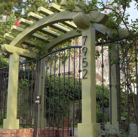fun and fresh new green paint color on entrance pergola provides a needed update